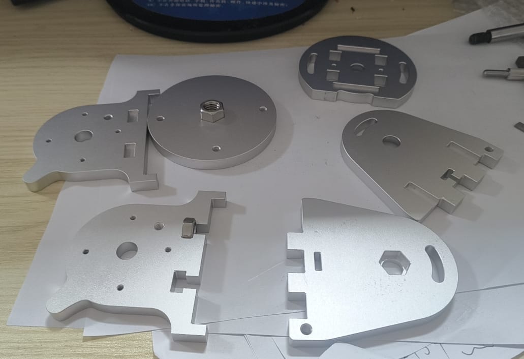 Custom CNC machined Aluminum 6061 mounting plates with bead blasted finish and installed hardware.