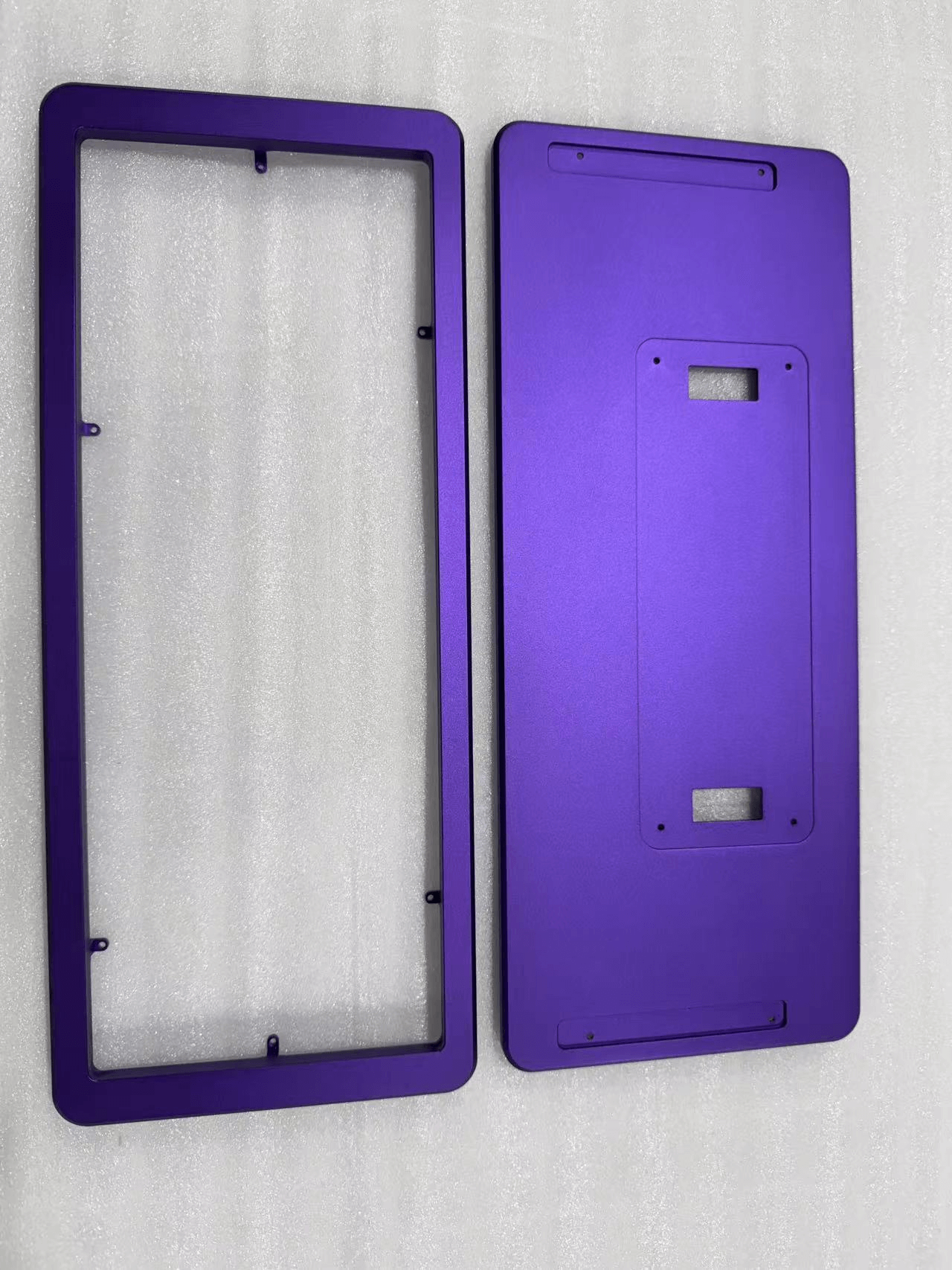 CNC machined aluminum keyboard chassis with deep purple anodized finish and sandblasted texture.